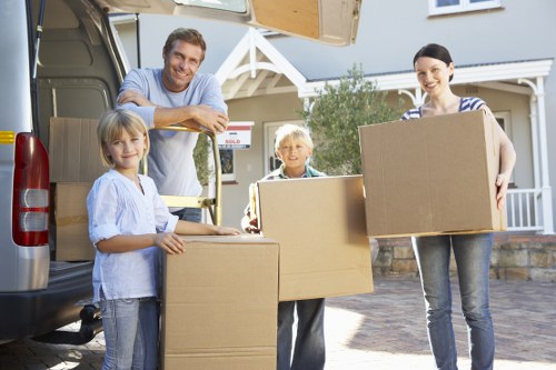 Packed moving boxes and furniture ready for removal truck hire