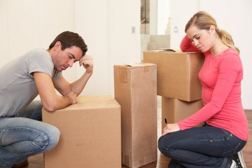 Professional movers navigating stairs during a furniture removal in Notting Hill