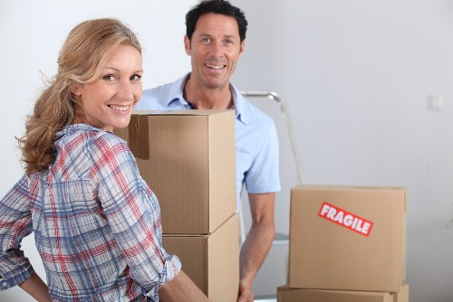 Professional movers handling packed boxes and furniture in Notting Hill
